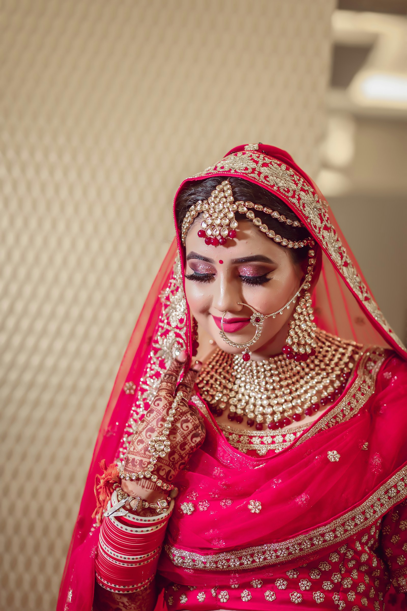 Indian bride in a red veil with ornate jewelry